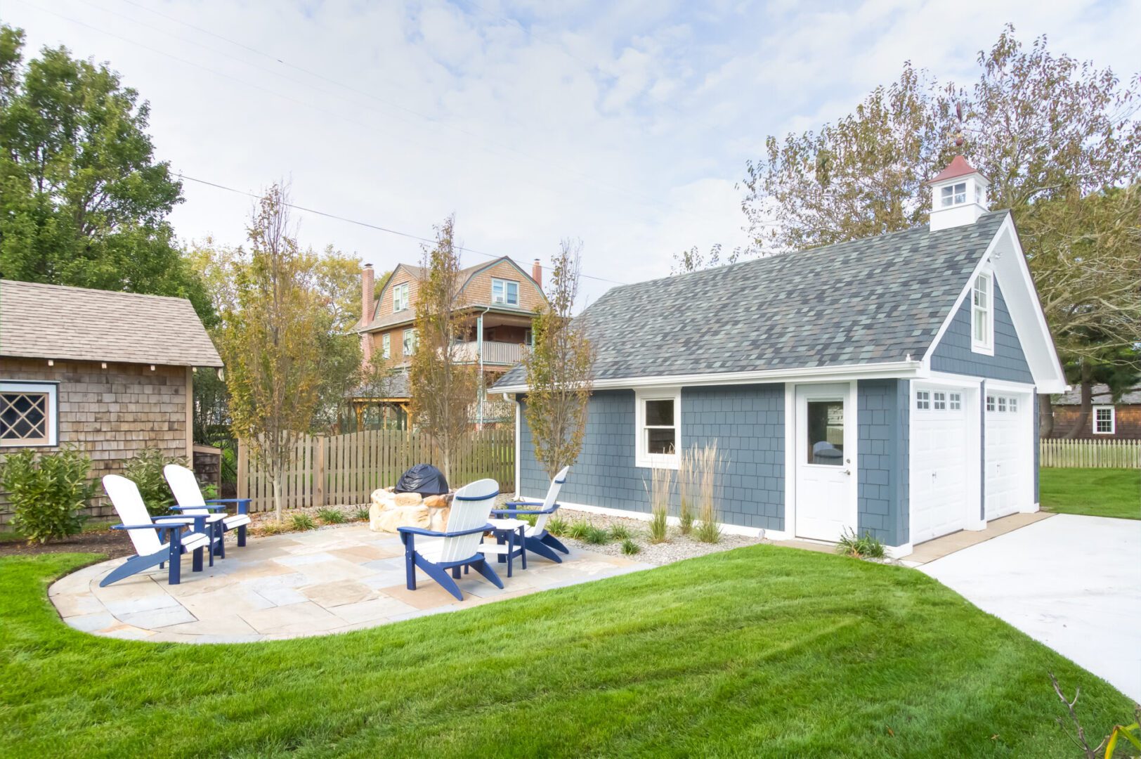 a house with a side lawn and chairs