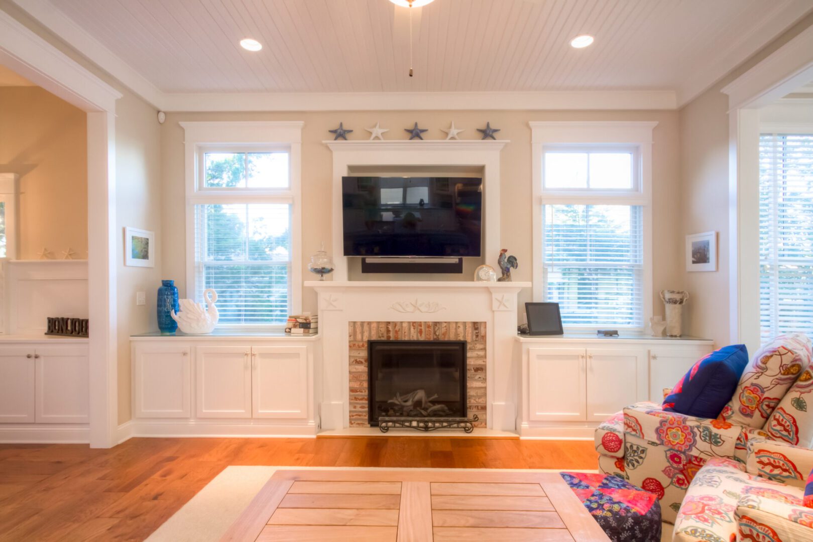 a living room with a LED TV and Fireplace