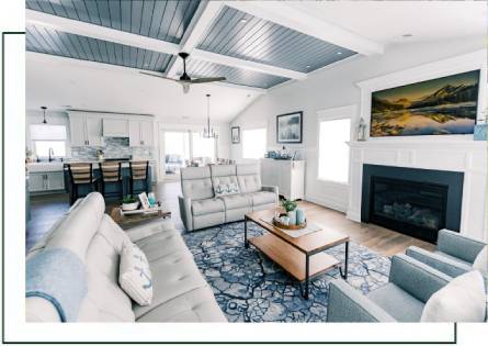 Spacious living room with fireplace and blue ceiling.